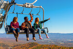 Three guests on a scenic chairlift ride at Massanutten Resort