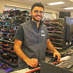 An employee adjusting rental skis at Massanutten Resort