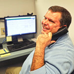 An employee on the phone answering guest questions