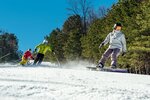 Skiers and Snowboarders on a mountain on a sunny day