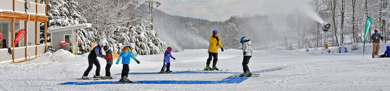 Guests taking a snow sports lessons at Massanutten Resort