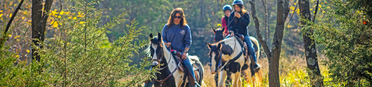 A group of people going on a horseback riding adventure at Massanutten Resort