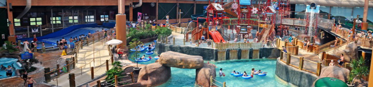 “Indoor swimming pool with water slides at Massanutten indoor water park VA