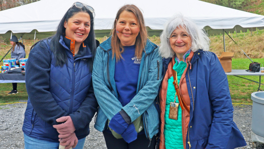 A photo of Masssanutten Employees Volunteering at Kid's Fishing Day outside by a lake
